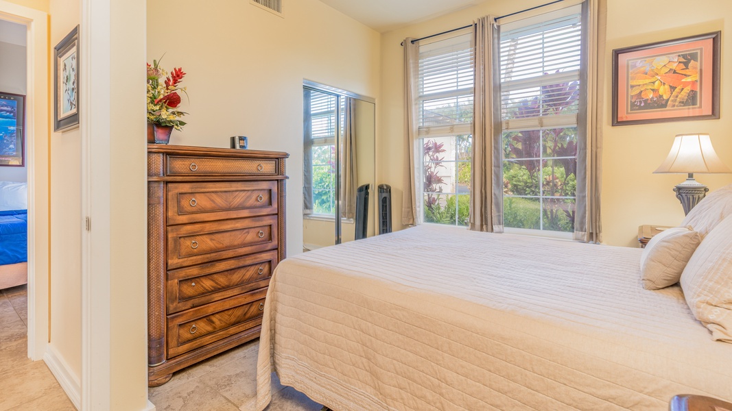 The second guest bedroom features a dresser and comfortable space.