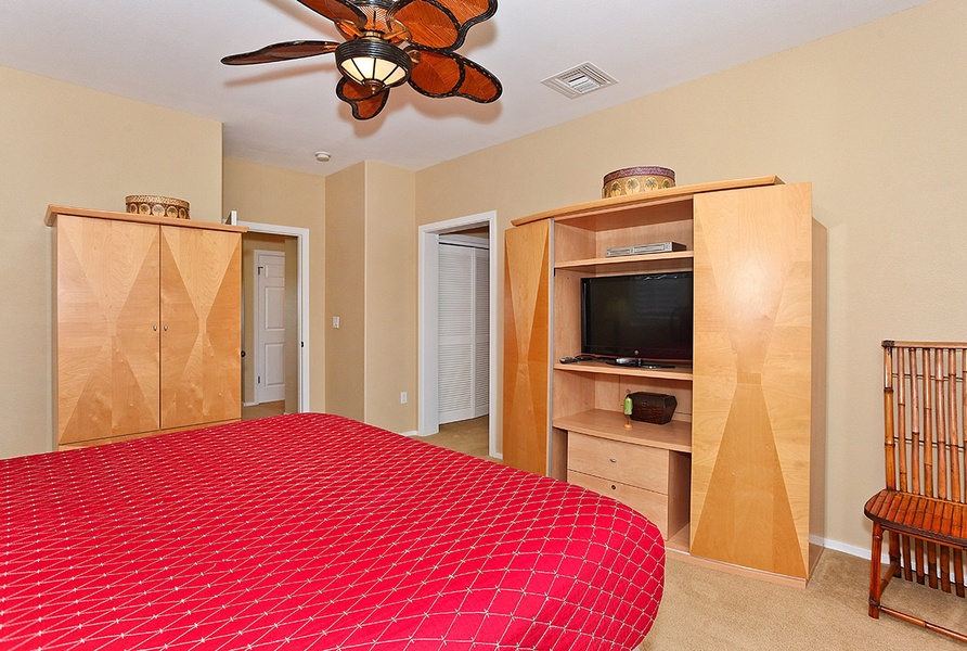 The primary guest bedroom with a TV and comfort for a restful slumber.