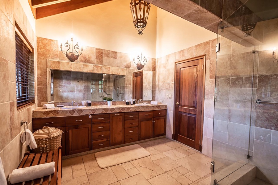 Freshen up in the luxurious ensuite bath with double sinks, a large mirror, and a walk-in shower.