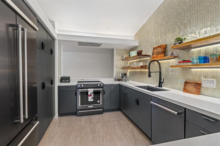 Chef's kitchen features a gas range, open layout, and thoughtful modern touches.