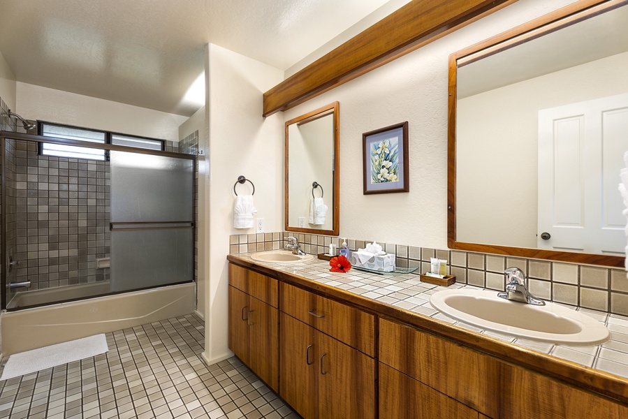 Guest bathroom with dual vanities, steps from the guest bedroom