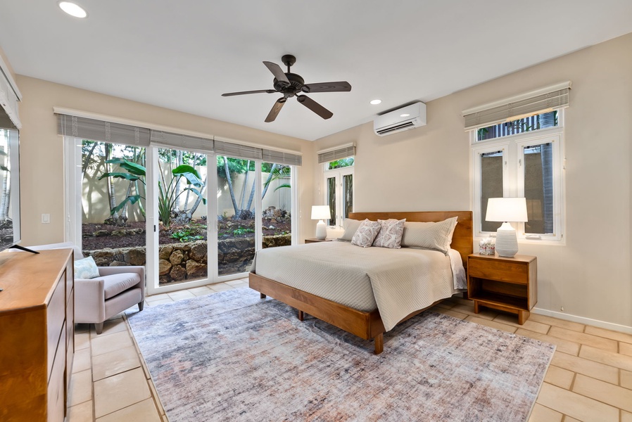 Wake up refreshed in your serene bedroom, where natural light streams through garden-facing windows and tropical plants create a peaceful retreat for your stay.