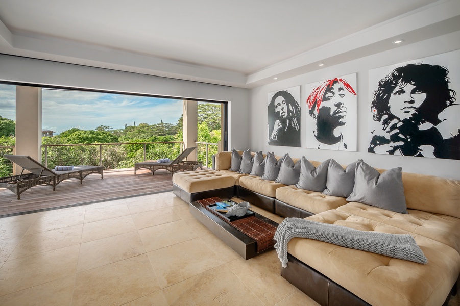 Lower-level living room with comfortable seating and expansive windows, offering beautiful views of the surrounding landscape.