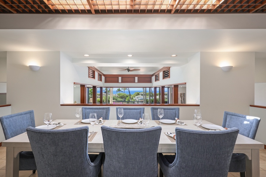 Stunning dining for eight which overlooks the great room and spacious lanai beyond