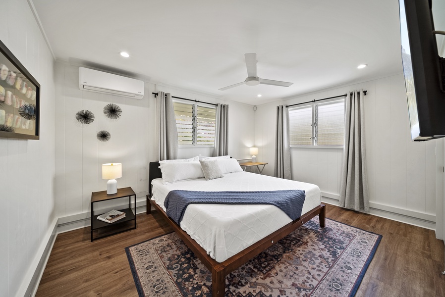Guest suite with a king bed, minimalist décor, and natural light creating a cozy, inviting atmosphere.