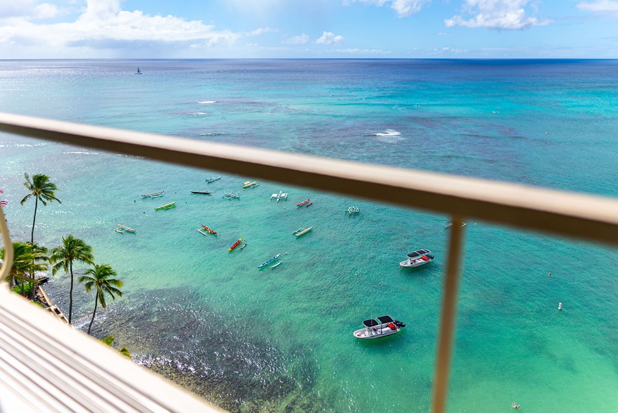 Stunning ocean vista with vibrant blue waters and boats below, creating a perfect backdrop for relaxation or photography.