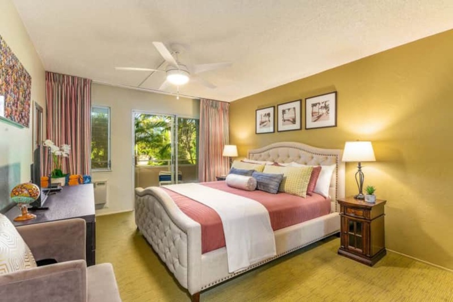 A king bed awaits in the primary guest suite with access to a private lanai