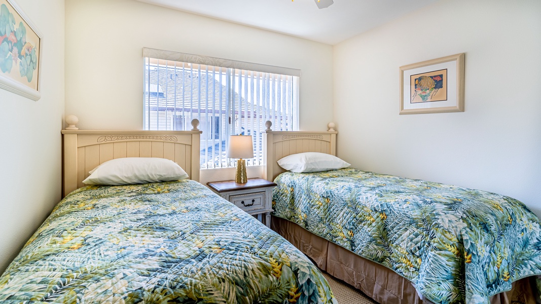 The third guest bedroom is well appointed with two twin beds for a restful slumber.