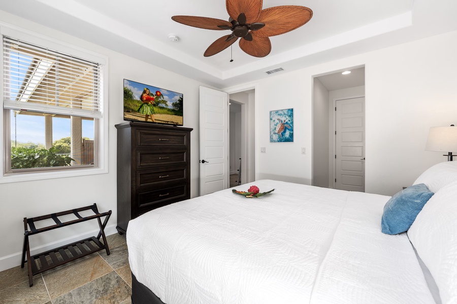 Downstairs guest bedroom with a plush king bed for restful nights.