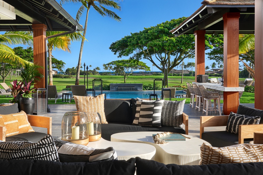 Enjoy outdoor elegance, offering views of the pool and lush tropical greenery.