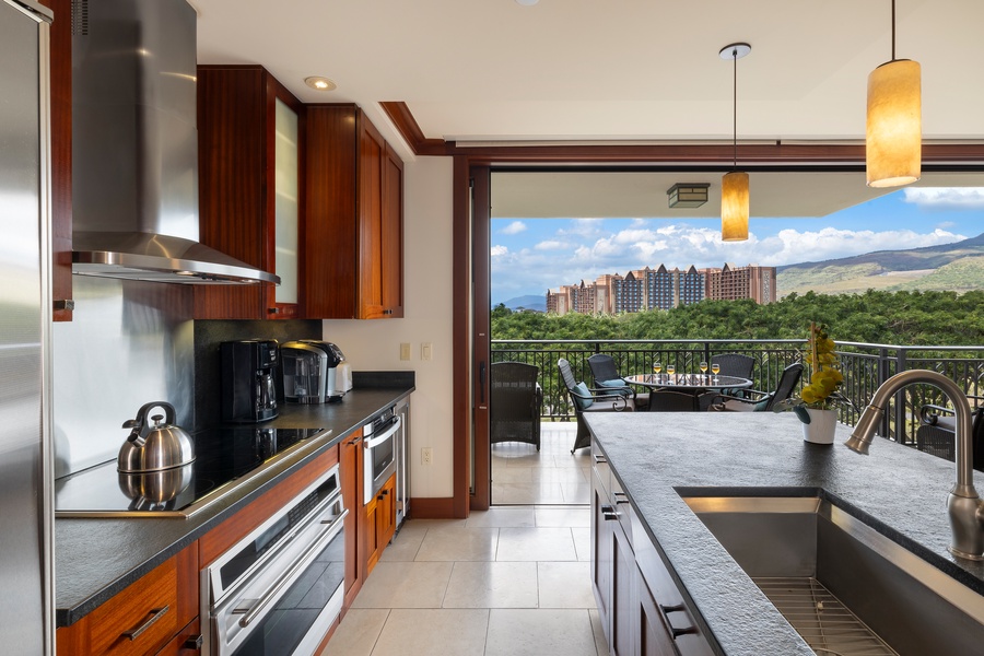 Cook in your gourmet kitchen while enjoying stunning resort views through floor-to-ceiling windows that frame tropical mountains and lush landscapes.