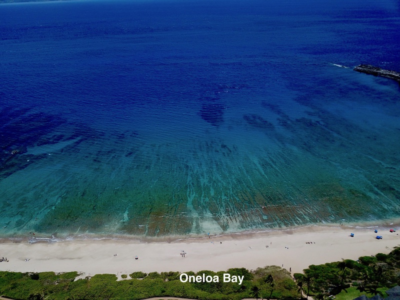 A breathtaking aerial view of Oneloa Bay, with its crystal-clear waters and sandy shoreline, perfect for a relaxing day at the beach.