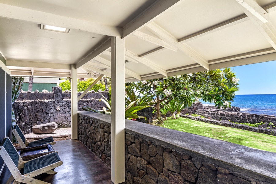 Lanai space extending into the lush yard, ideal for quiet relaxation.