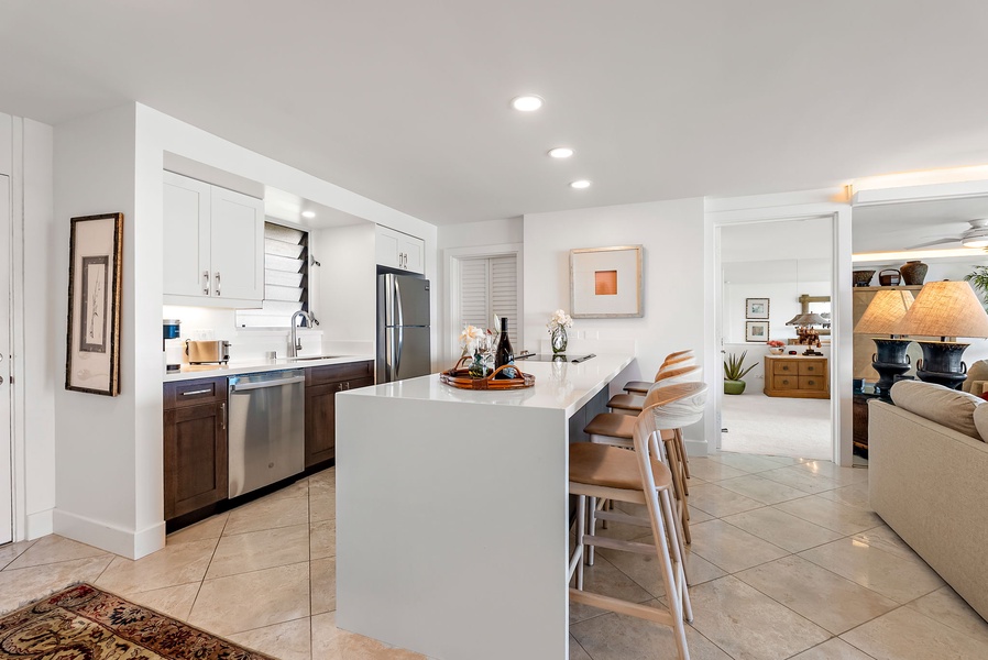 The gourmet kitchen is thoughtfully designed for connection and convenience, with full-size appliances, sleek countertops, and a central island perfect for prepping meals or hosting friends.