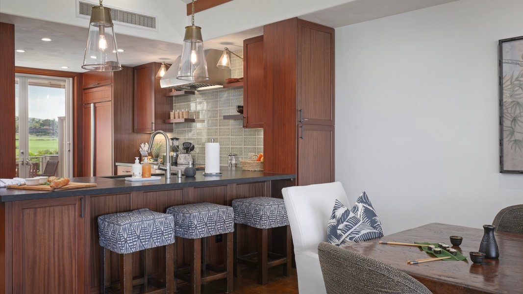 The kitchen bar has seating for three, perfect for quick meals and entertainment.