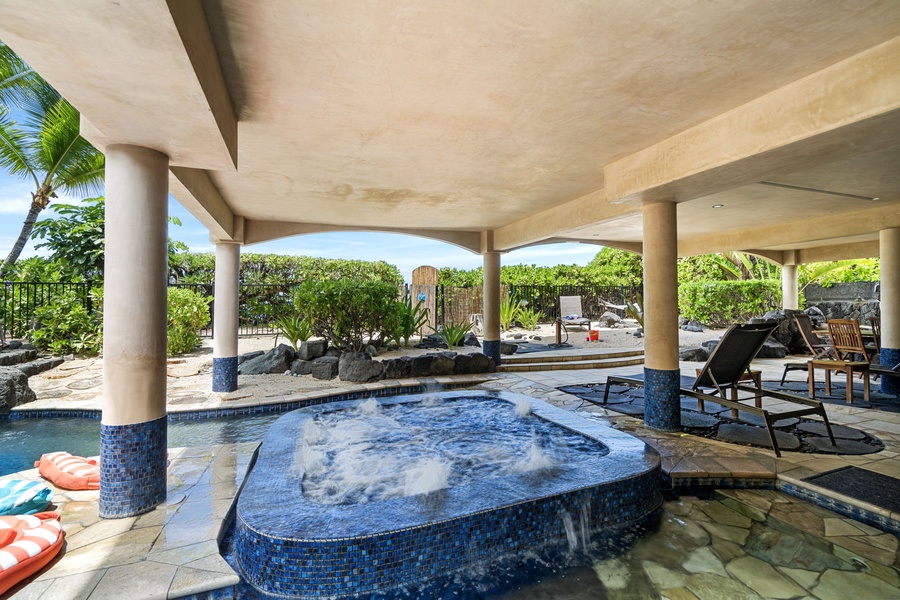 Bubbling spa with overhead shade and garden ambiance—relax muscles after a beach or hike adventure.