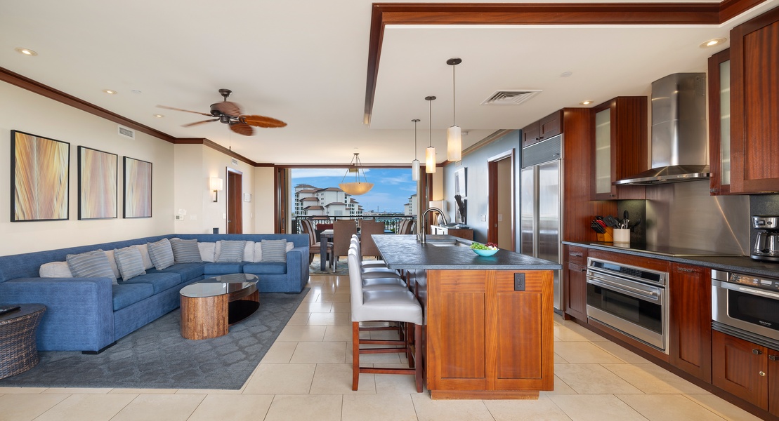 Step into your stunning open-plan living space where rich wood tones meet ocean blues, creating the perfect backdrop for your Hawaiian getaway.
