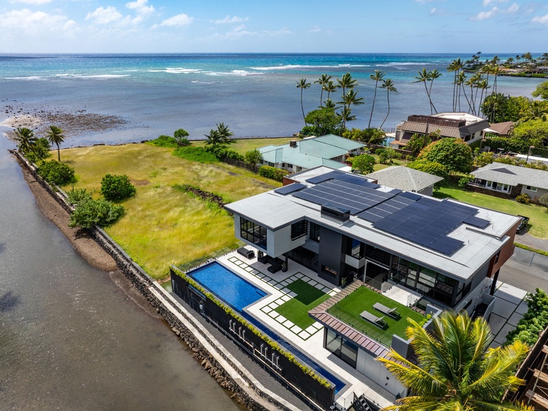 An exclusive aerial angle highlights the villa’s contemporary lines, private pool, and oceanfront perch.