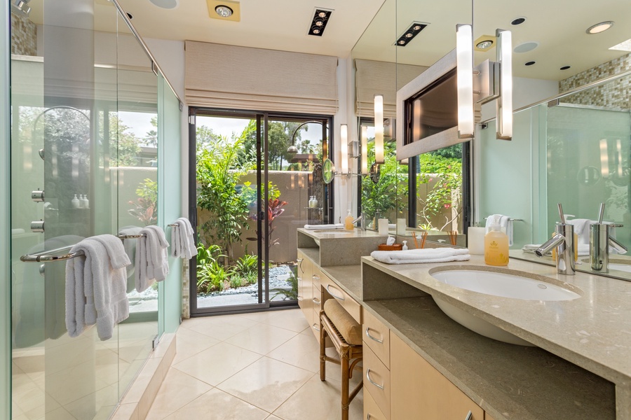 Primary Bath w/Dual Vanity, Flatscreen TV, Privacy Commode, Walk-In Shower & Sliding Doors to Outdoor Shower Garden.