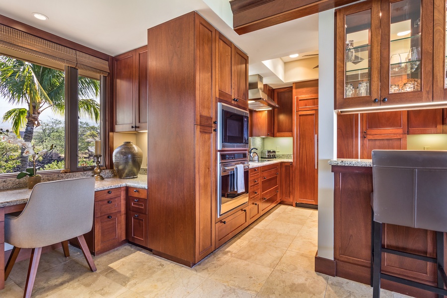 Built-in desk and bar seating frame the kitchen entrance.