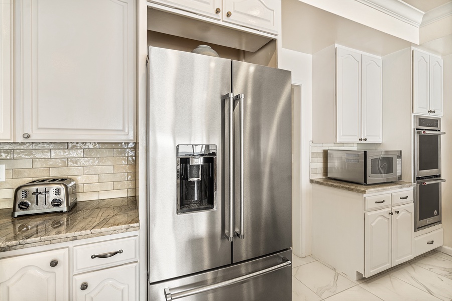The fully renovated kitchen, with its top-of-the-line stainless steel appliances and large island, are a chef’s dream