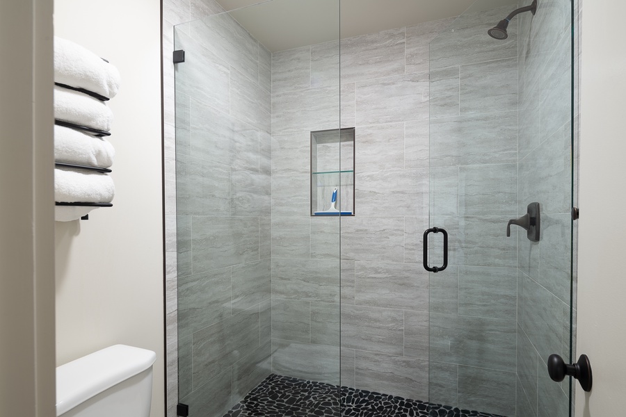 Ensuite bath with a walk-in shower in a glass enclosure.