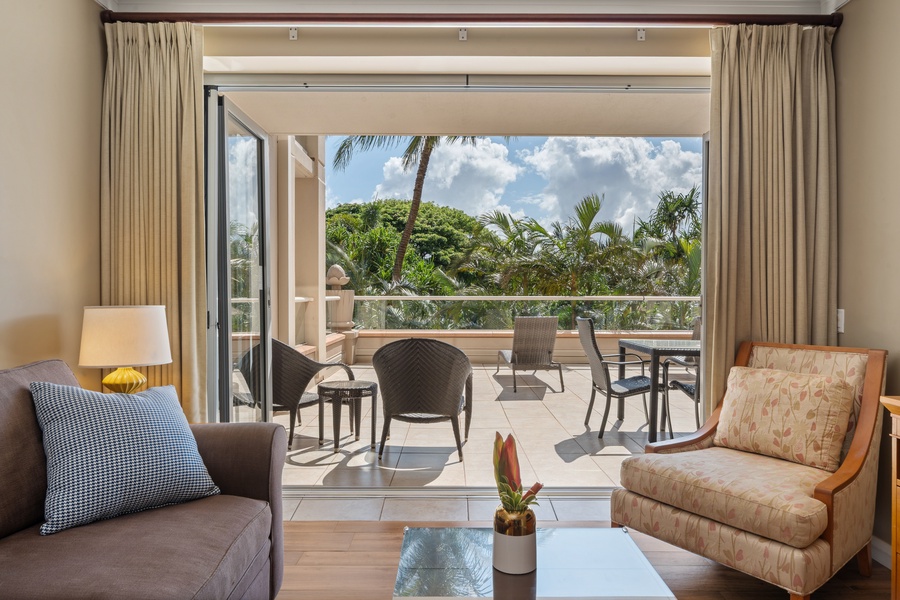 The living room in Honua Kai Konea 230/232 opens fully to the outdoors, blending comfort and fresh air