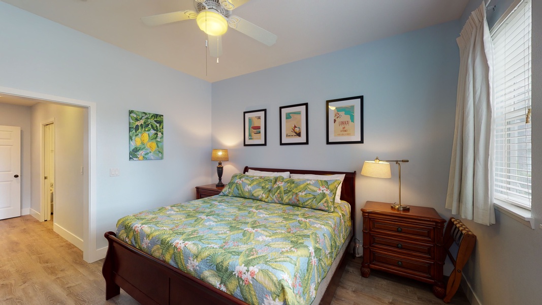 The comfortable primary bedroom has scenic views to wake up to.