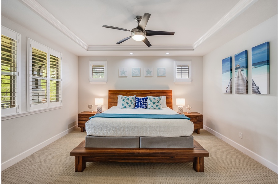 Tranquil 2nd floor primary bedroom with spacious balcony overlooking open space.