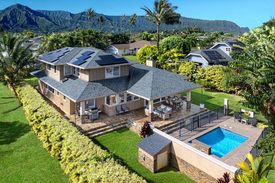 Stunning Hawaiian retreat with mountain backdrop, featuring spacious home with private pool and lush tropical landscaping in peaceful residential setting.