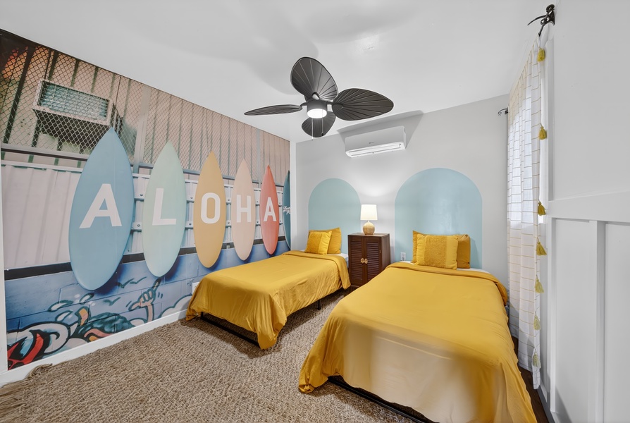 Bright and cheerful twin bedroom with island-inspired decor, perfect for a restful stay.