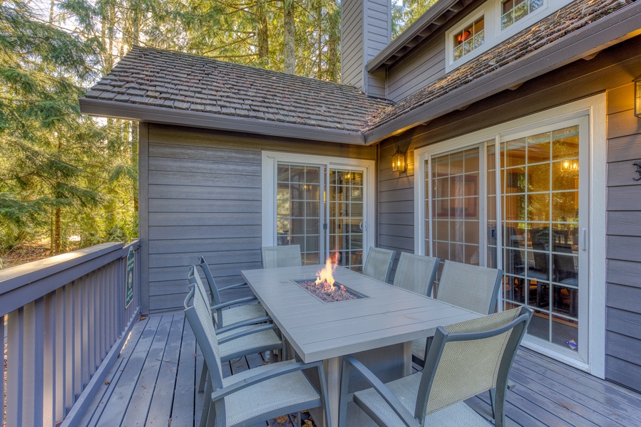 Al fresco dining with a cozy fire on the deck, accessible through the living area, enjoy your meals with a view!