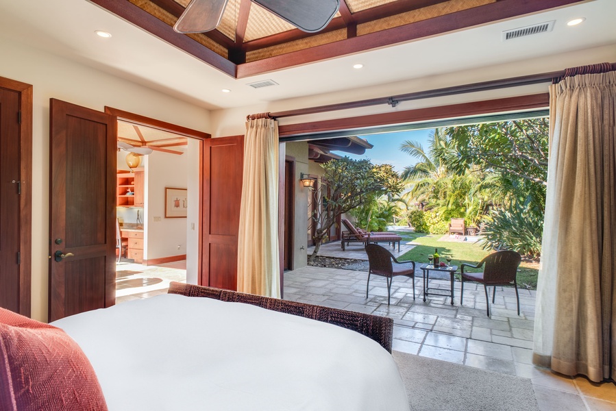 The bedroom with open pocket doors for seamless indoor-outdoor living.