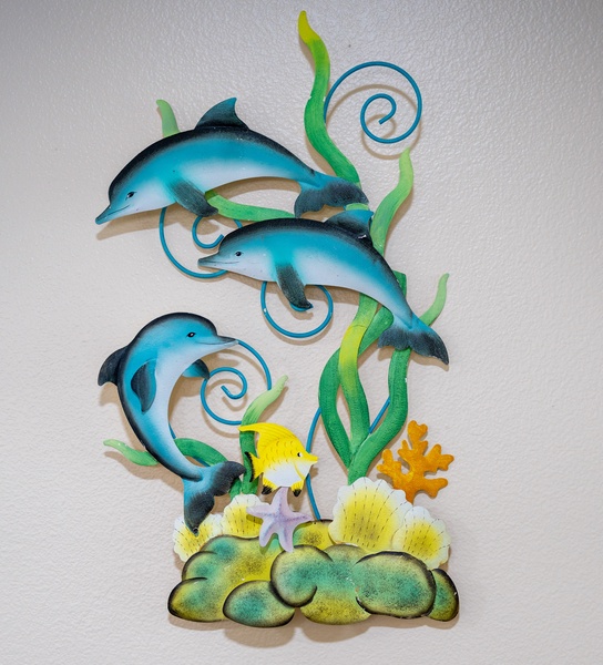 The dolphins at play sculpture in the home.