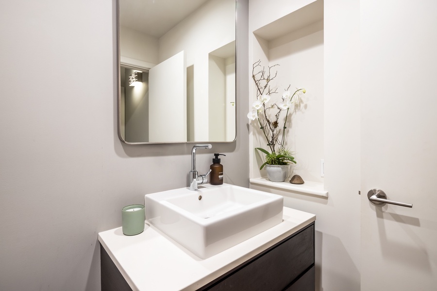 Powder room with elegant modern fixtures and stylish accents.