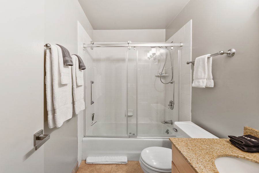 The shared bathroom right off the hallway comes with a shower/tub combo.