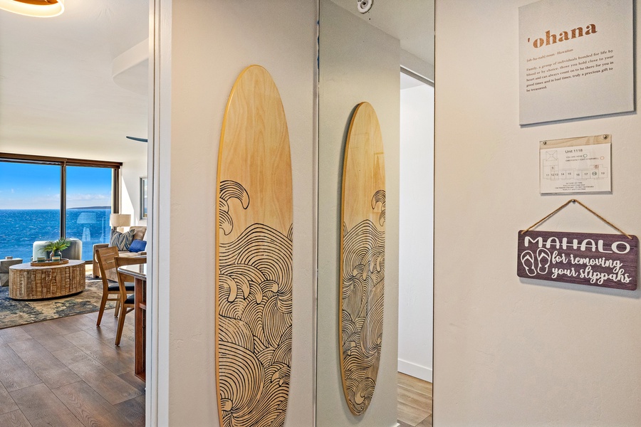 A beautifully crafted surfboard art piece adorns the hallway, offering a touch of coastal charm and bringing the island vibe indoors