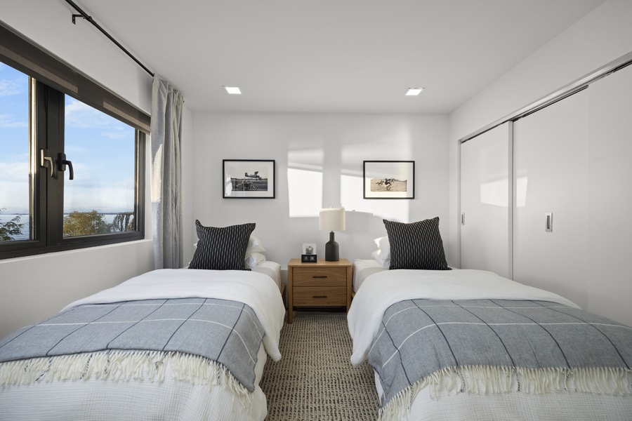 Cozy guest room with twin XL beds, soft linens, and natural light — perfect for restful nights.