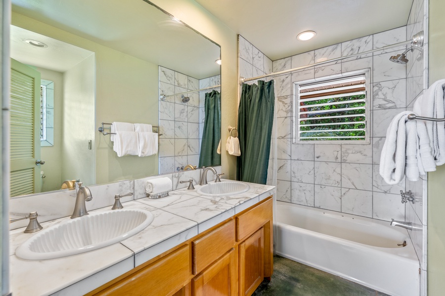 Start your day in the spacious bathroom with double sinks and a convenient shower and tub combo.