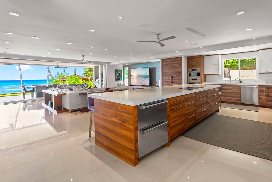 Picture yourself in this stunning oceanfront kitchen where you'll cook and gather against a backdrop of endless blue sea views. The sleek chef's kitchen flows seamlessly to your own private paradise outside.