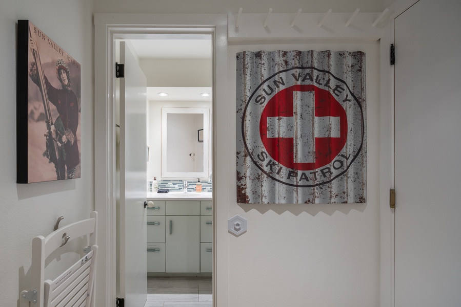 Step into a blend of alpine charm and modern elegance, featuring a nostalgic Sun Valley Ski Patrol sign, opening up to the ensuite bathroom.