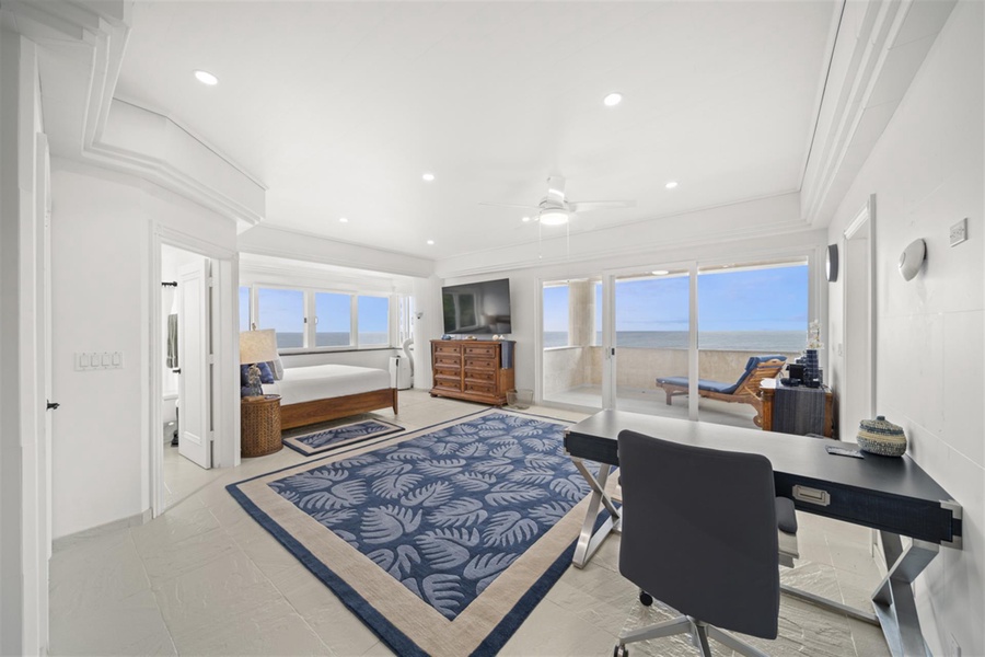 The elegant suite has a workspace and stunning ocean scenery.