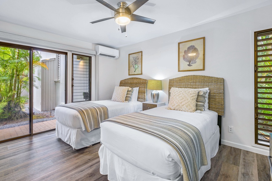 This cozy bedroom features a king bed that can convert to two twin beds and offers access to the lanai, perfect for a relaxing retreat.