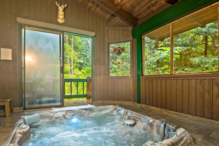 Soak in the private hot tub, tucked discreetly for a serene outdoor experience.