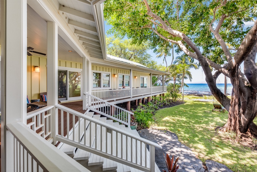 Expansive wrap around lanai with staircase to private lawn and beachfront