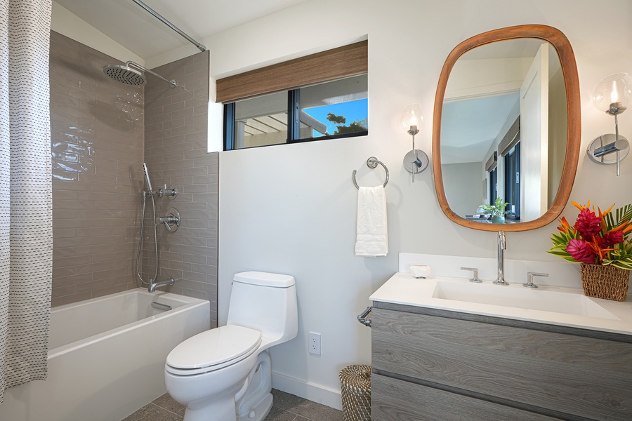 Spa-inspired third guest bathroom with shower/tub combo serene tones for ultimate relaxation.