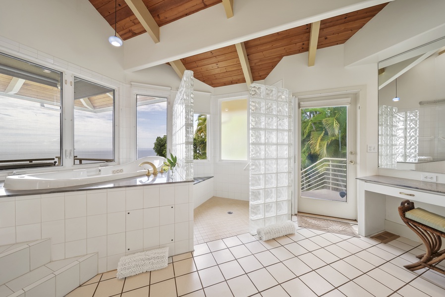 Soak in your luxurious bath while enjoying breathtaking ocean views through floor-to-ceiling windows in this stunning spa-like bathroom retreat.