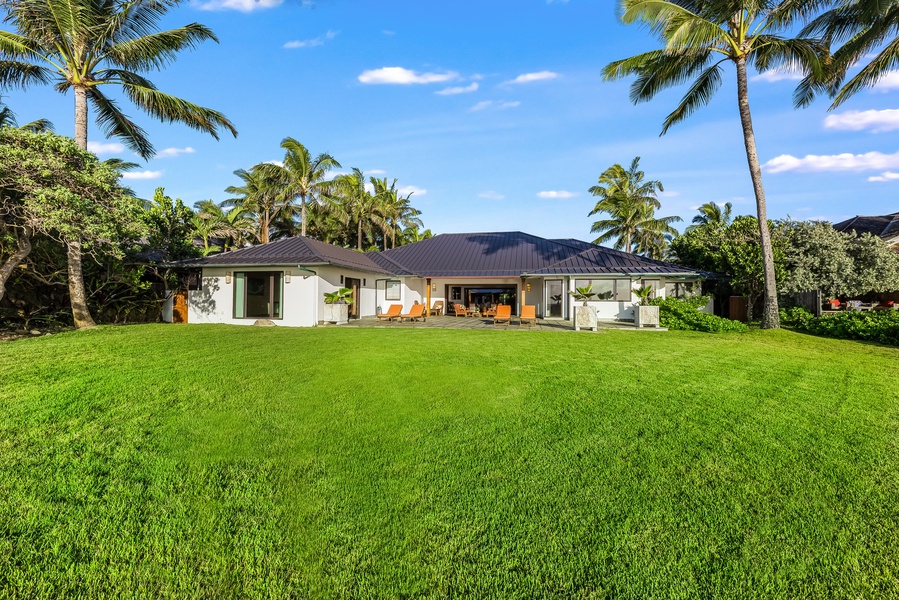 A sweeping view of the estate from the gardens reveals its graceful design along the coastline.