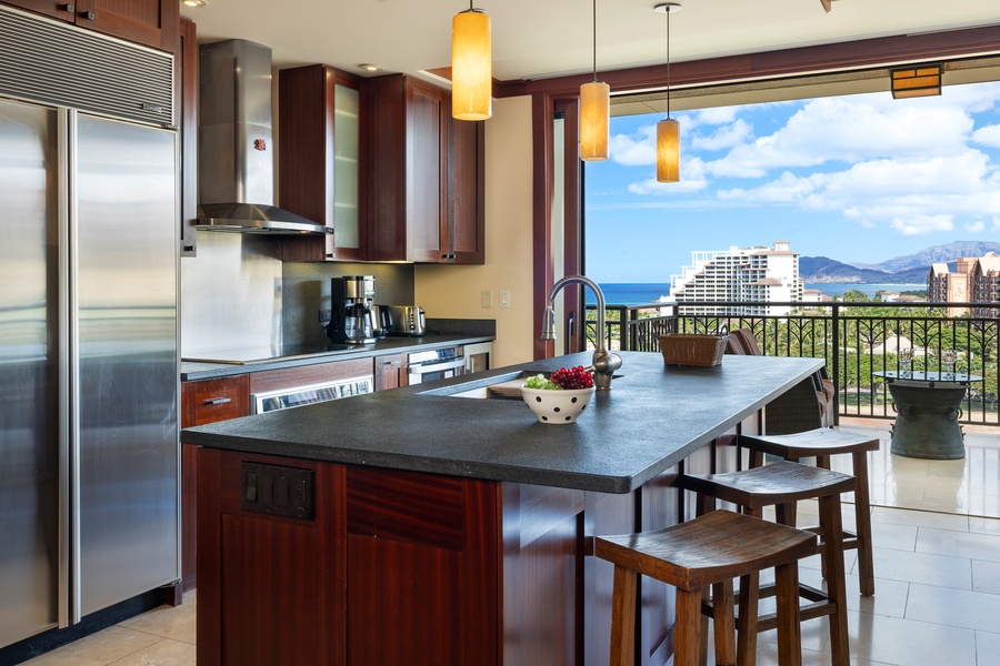The chef’s kitchen features Sub-Zero and Wolf appliances, granite counters, and a wine cooler.