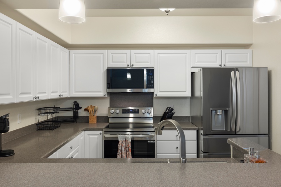 Cook your favorite meals in this bright, fully-equipped kitchen with stainless steel appliances and ample counter space for all your culinary adventures.